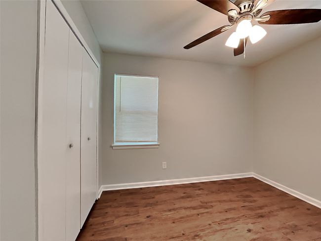 Unfurnished bedroom featuring a closet, wood finished floors, and ceiling fan | Image 6
