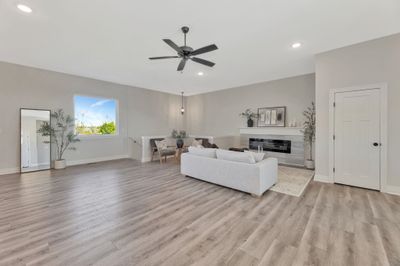 Living room with light hardwood / wood-style floors and ceiling fan | Image 2