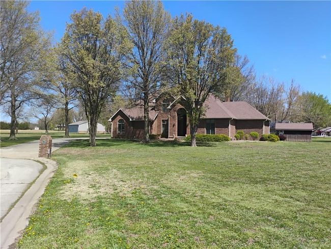 View of front of house featuring brick siding and a front lawn | Image 8