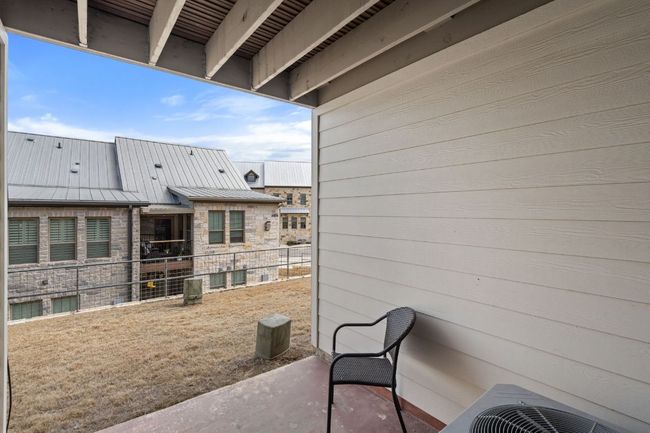 First Floor patio with view of common grounds; central air condition unit | Image 32