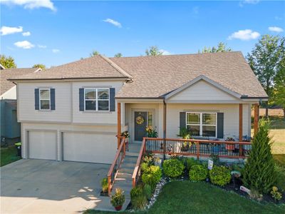 View of front of home with a garage and a porch | Image 1