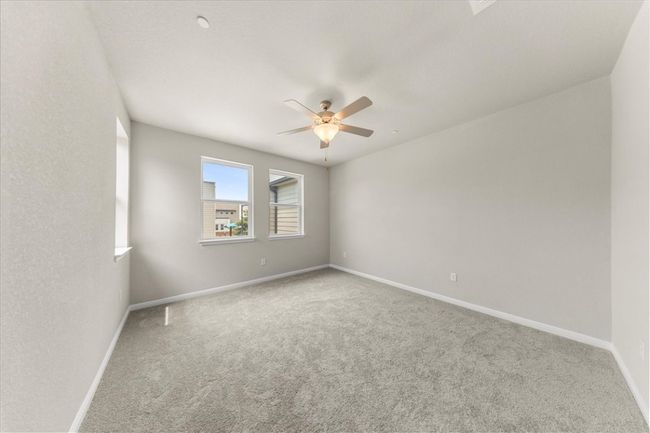 Empty room featuring carpet, a ceiling fan, and baseboards | Image 24