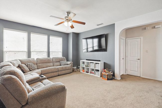 Living room featuring carpet, a ceiling fan, and arched walkways | Image 27