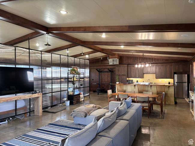 Living room featuring lofted ceiling with beams | Image 58