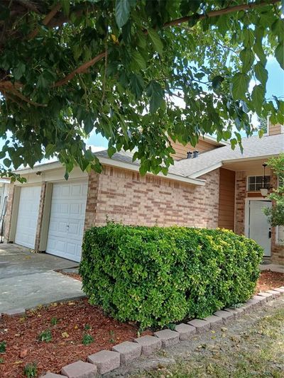 View of property exterior with a garage | Image 1