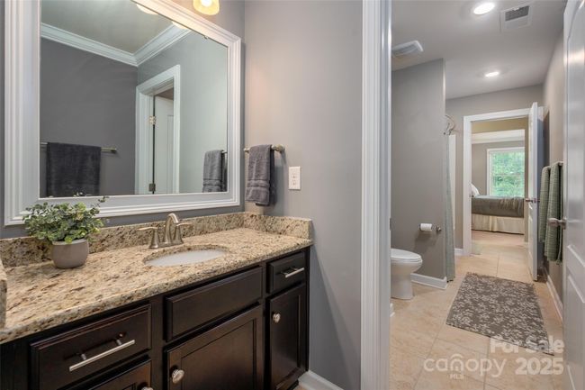 Jack N Jill bath with each room having it's own vanity and sharing the tub/shower | Image 32