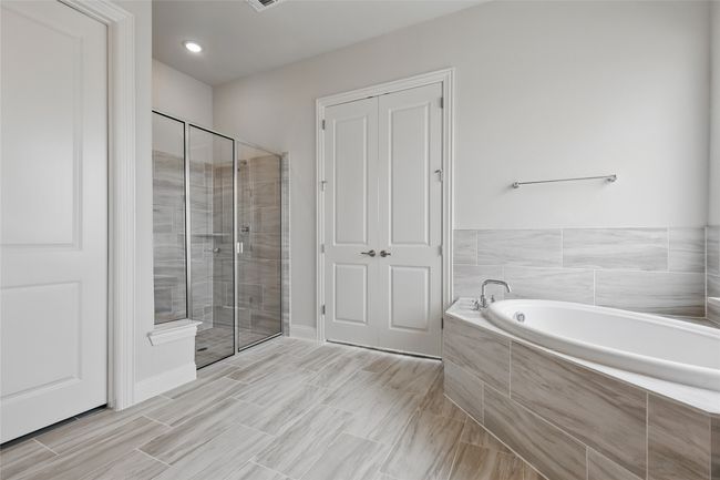 Bathroom with a stall shower and a garden tub | Image 19