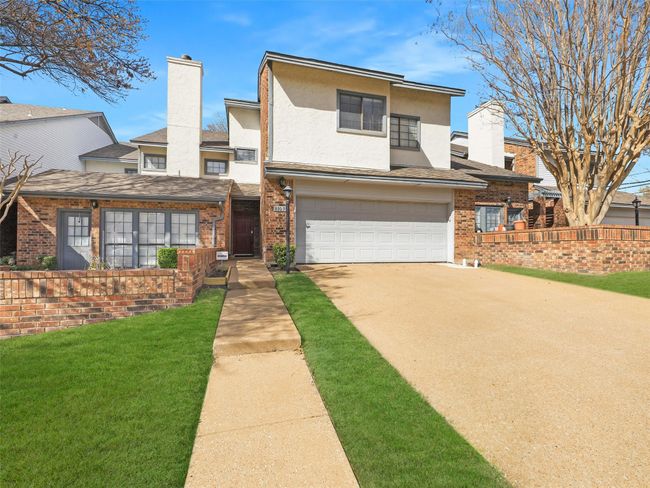 View of front of house featuring brick siding and a chimney | Image 35