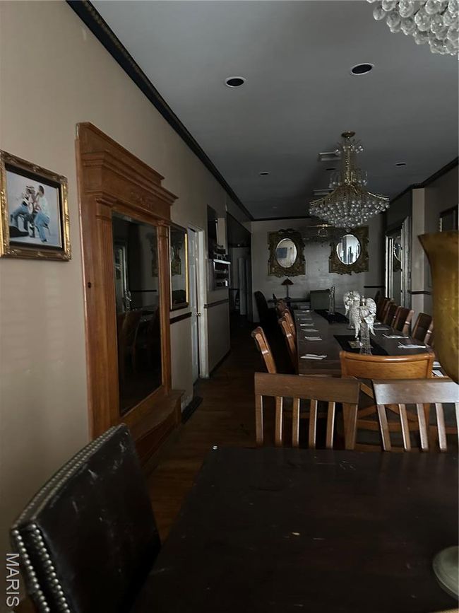 Dining space with recessed lighting, ornamental molding, a notable chandelier, and wood finished floors | Image 15