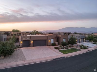 Pueblo-style house featuring a mountain view and a garage | Image 2