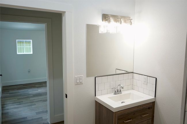 Bathroom with vanity, decorative backsplash, and wood finished floors | Image 17