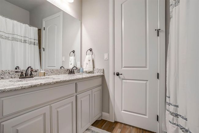 Full bath featuring double vanity and wood finished floors | Image 25