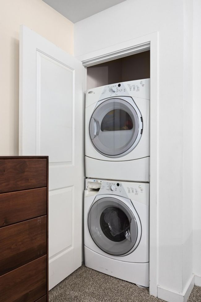 Laundry area featuring estacked washer and dryer | Image 13