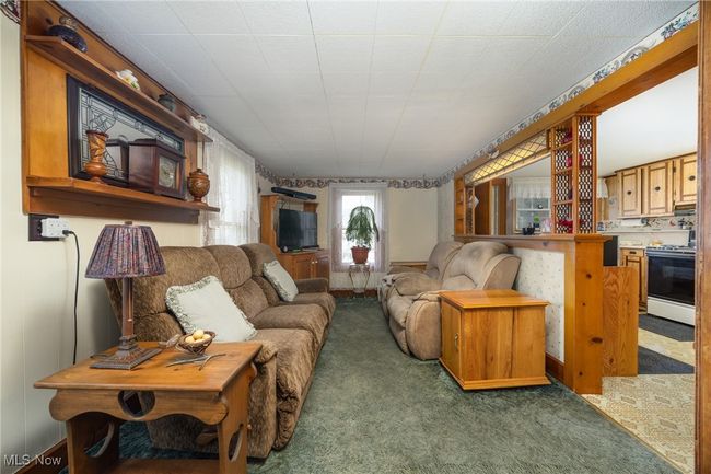 Living area with carpet floors | Image 13