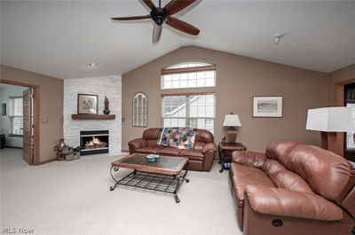 Carpeted living room featuring high vaulted ceiling and ceiling fan | Image 3