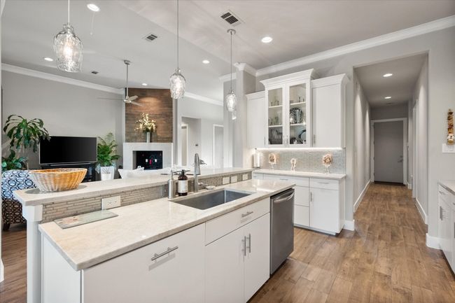 Kitchen offers side counter space with glass doors perfect to use as serving area or coffee bar. | Image 9