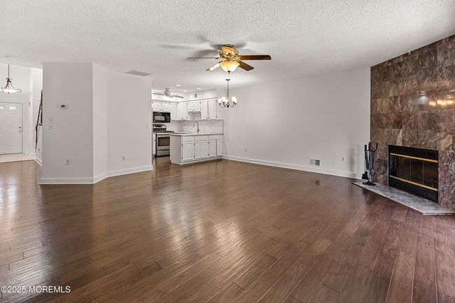 Rich wood floors are showcased throughout with the optimal open flow between Living, Dining and Kitchen. | Image 10