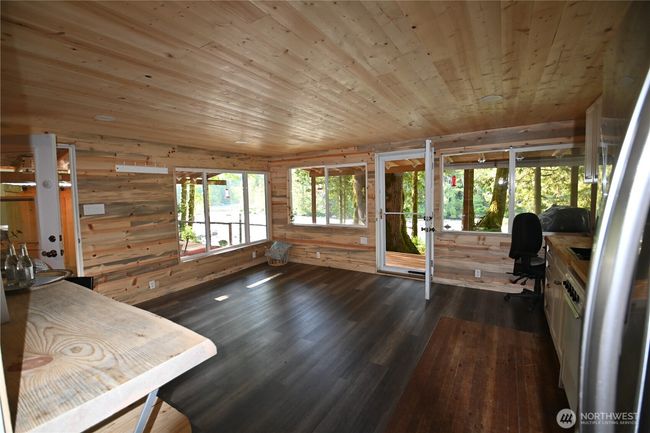 Bunkhouse features new doors, windows, updated flooring, half bath - blending modern upgrades w/rustic character. A touch of original fir floor has been preserved to stencil or paint your own design & infuse the space with personality. | Image 24