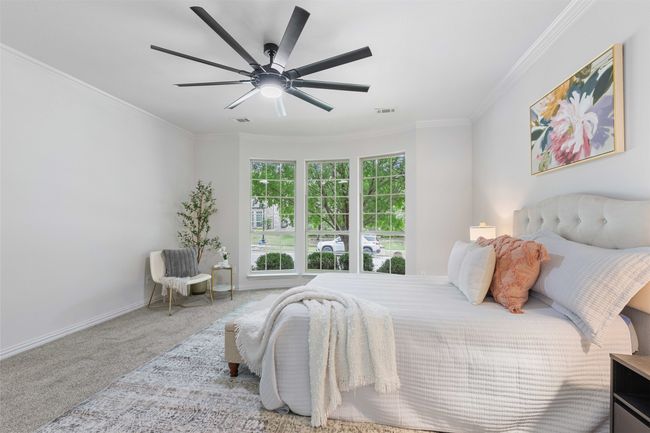 Carpeted bedroom featuring ornamental molding, a ceiling fan, visible vents, and baseboards | Image 17