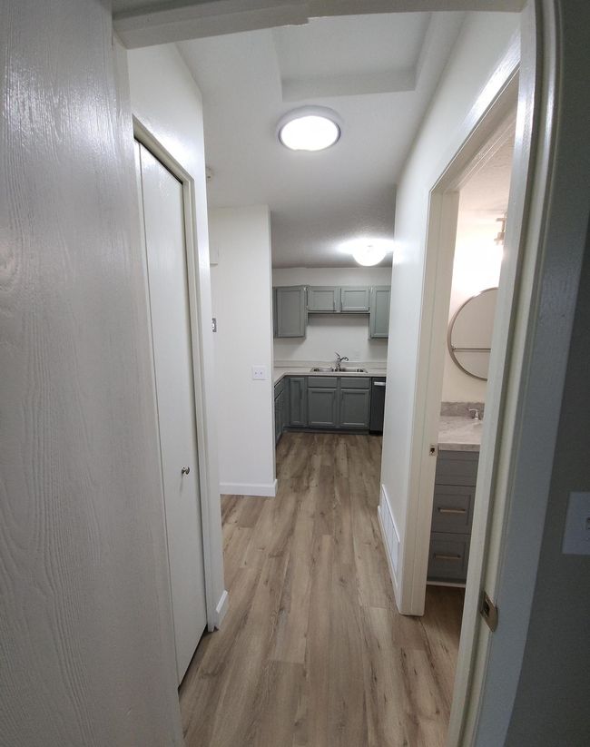 Hallway from bedroom to kitchen. Very nice lighting through-out the home! | Image 8