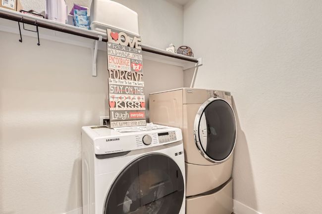 Laundry area featuring washer and clothes dryer and baseboards | Image 28