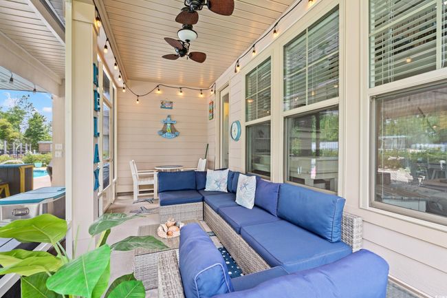 View of patio with outdoor lounge area and a ceiling fan | Image 29