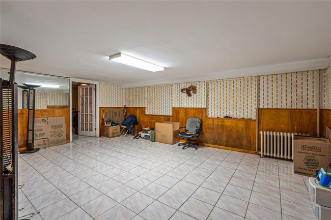 Office area featuring wallpapered walls and radiator heating unit | Image 19