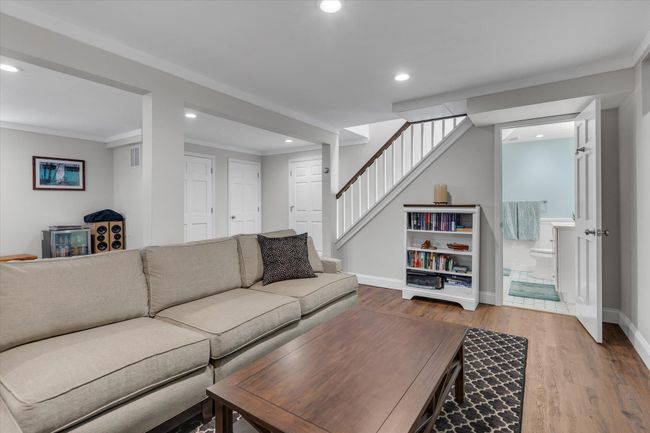 Living area featuring stairs, wood finished floors, baseboards, and recessed lighting | Image 13