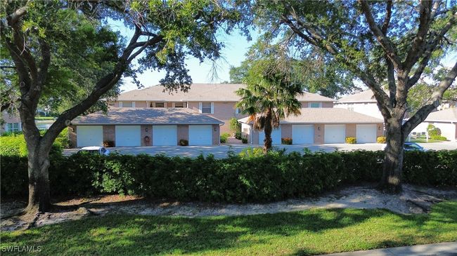 View of front of property featuring a front yard and a garage | Image 26