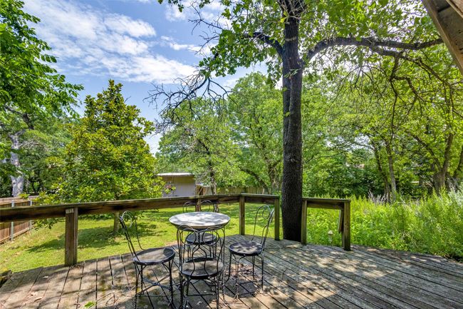 Deck with a lawn and view of wooded area | Image 5
