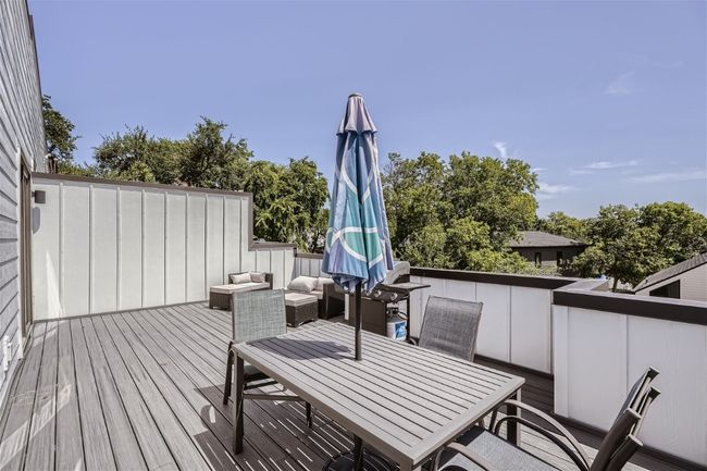 Enjoy the upstairs expansive private deck, ideal for outdoor entertaining. | Image 19
