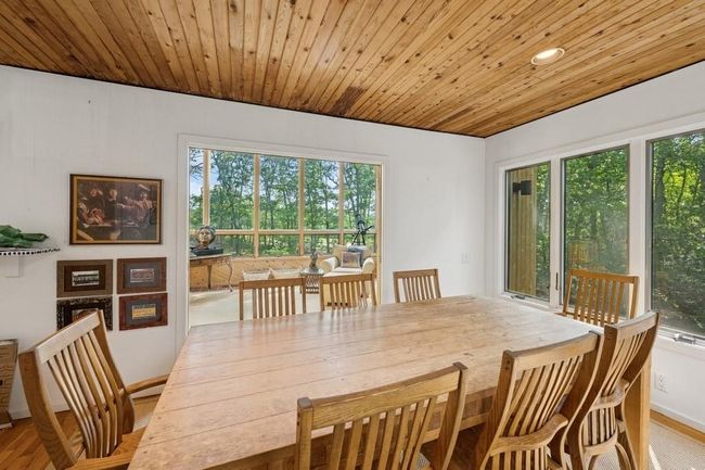 Dining room with wood ceiling, wood finished floors, and baseboards | Image 5