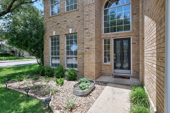 Stately entry with quality of all brick and attractive low maintenance flower beds. | Image 4