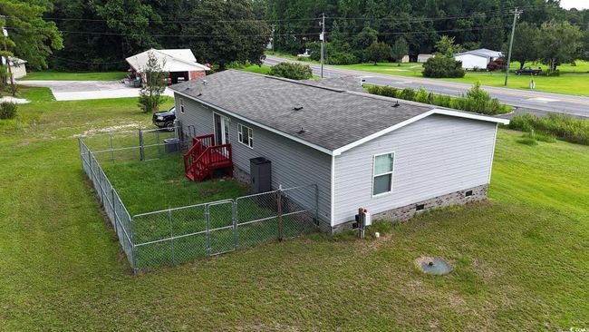 View of property exterior featuring roof with shingles and crawl space | Image 5