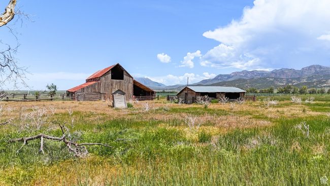 Back of property featuring a barn, a mountain view, an outdoor structure, and a view of countryside | Image 15