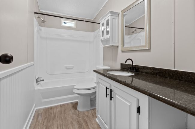 Full bath with bathing tub / shower combination, vanity, wood finished floors, and a textured ceiling | Image 28