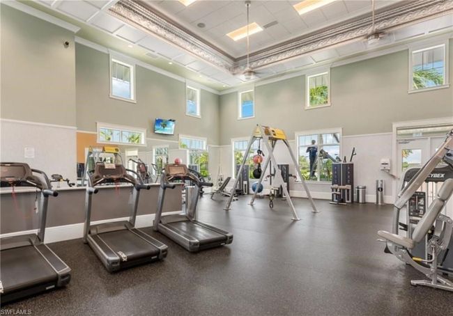 Workout area with a high ceiling and ornamental molding | Image 25