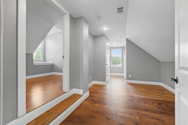 Additional living space with plenty of natural light, wood-type flooring, lofted ceiling, baseboards, and recessed lighting | Image 39