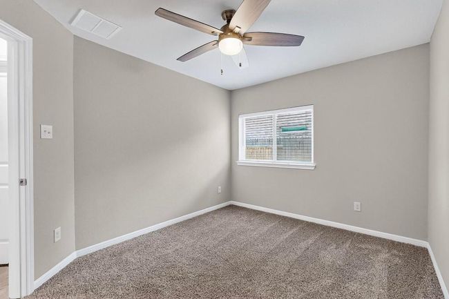 Spare room with a ceiling fan and carpet | Image 25