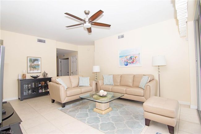 Spacious living room allows for terrific furniture placement options and includes the cool coastal furnishings. | Image 4