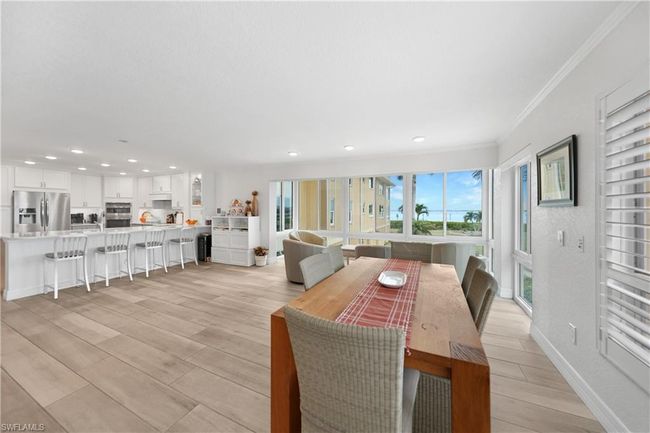 Dining space with light hardwood / wood-style flooring and ornamental molding | Image 11