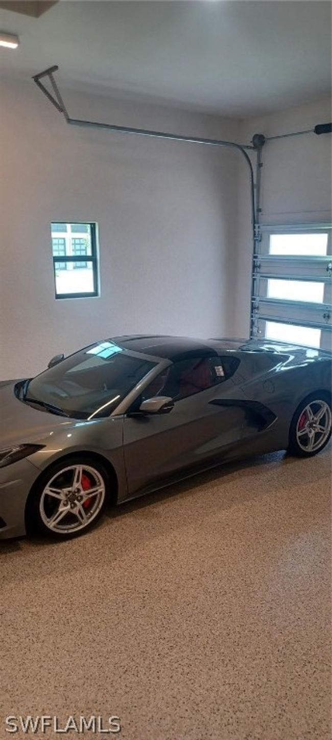 12 foot high ceiling will accomodate car lifts and the 8' high garage door will allow higher vehicle parking. Show-stopper epoxy flooring has extra flaking and slip resistance. | Image 22