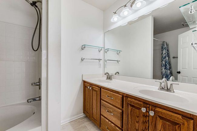 Primary bath with double vanities, new faucets and new floor. | Image 17