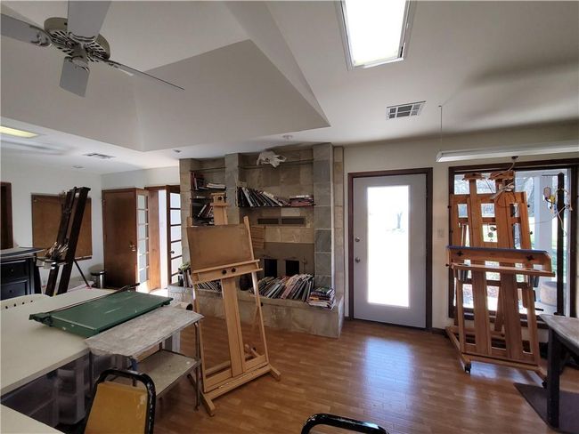 Miscellaneous room with visible vents, wood finished floors, and a ceiling fan | Image 53