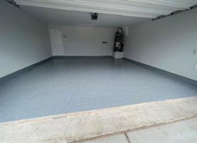 Garage with baseboards | Image 26
