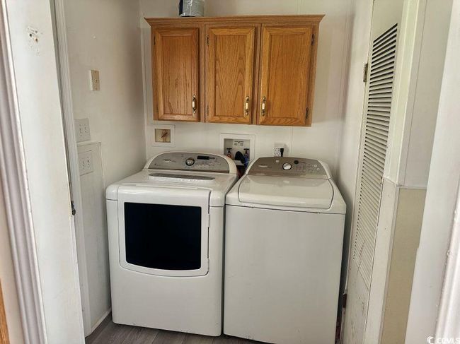 Washroom with cabinet space, washer and dryer. | Image 8
