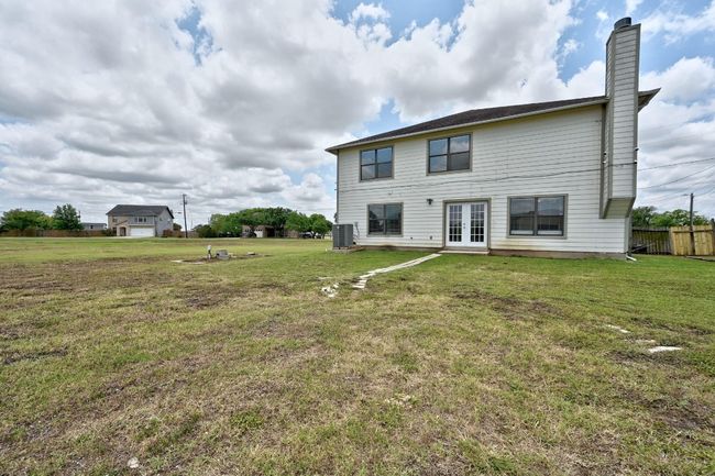 Back of property featuring french doors, cooling unit, and a chimney | Image 32