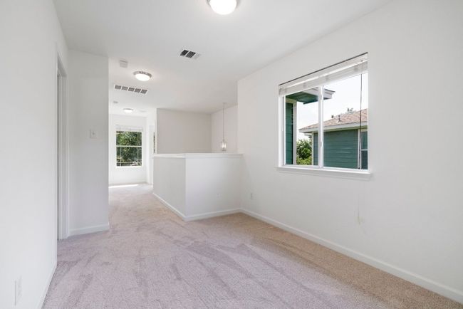 Upstairs, there's a flex larea that's perfect for a play room, or casual sitting room. | Image 19