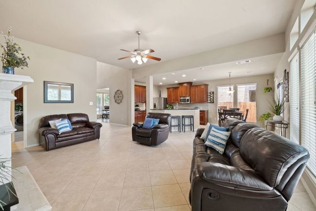 Living room with ceiling fan, light tile patterned floors, and recessed lighting | Image 13