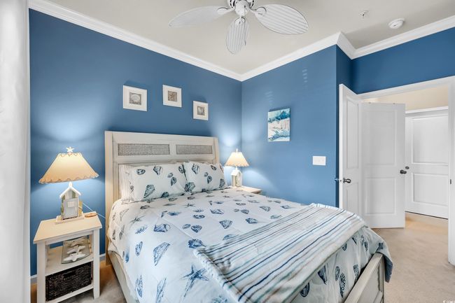 Bedroom with carpet, ornamental molding, and ceiling fan | Image 11